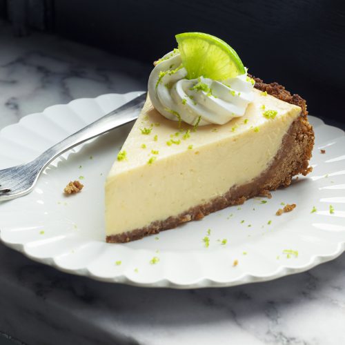 A slice of key lime pie with whipped cream